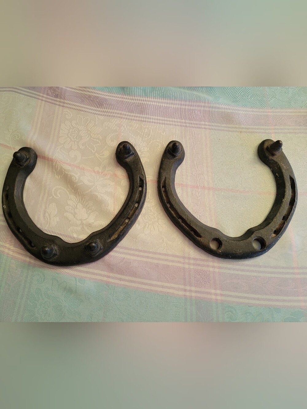 Two vintage horseshoes designed for draft horses